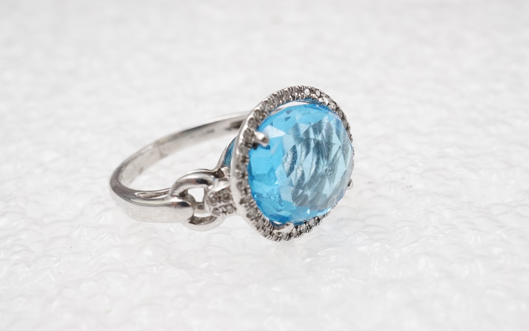 A blue topaz and diamond ring